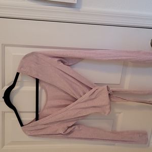 Lululemon Tied To It Wrap (light pink). Can be worn with a high neck line or v